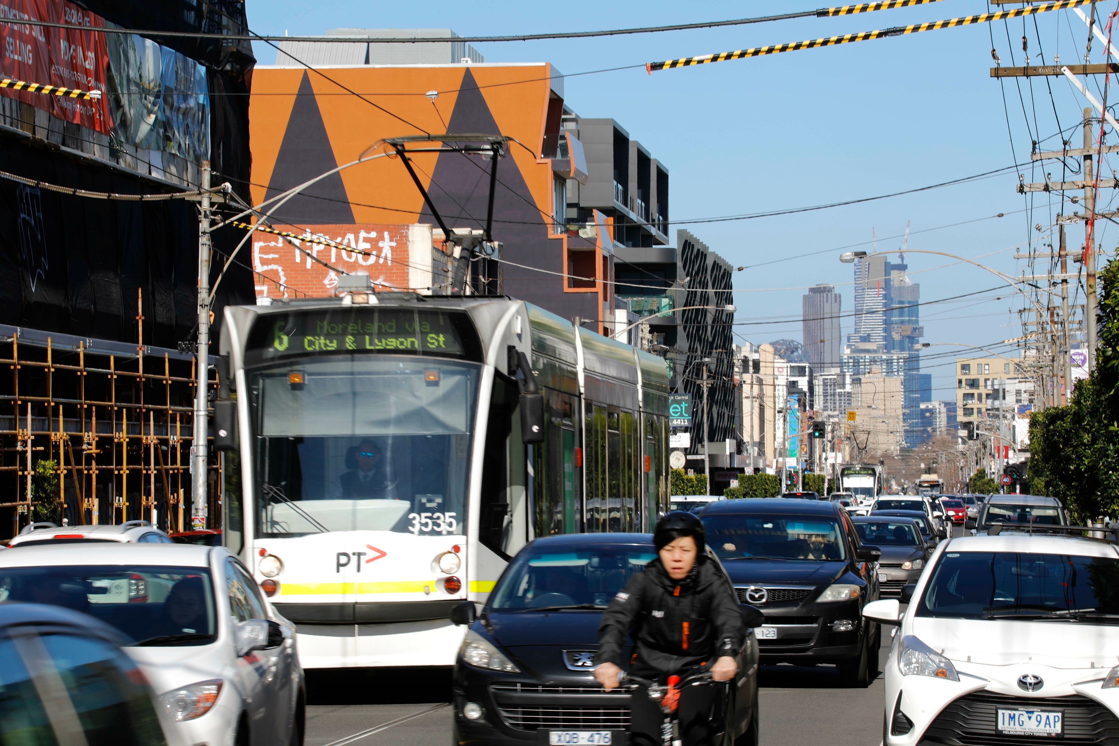 Lygon st traffic with tram cars bikes